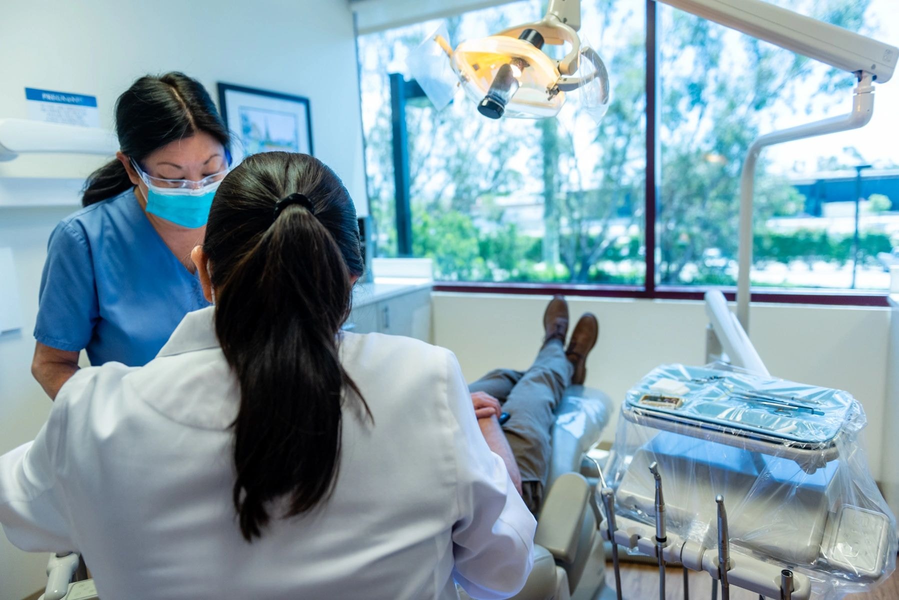 Dentist examining patient in modern clinic