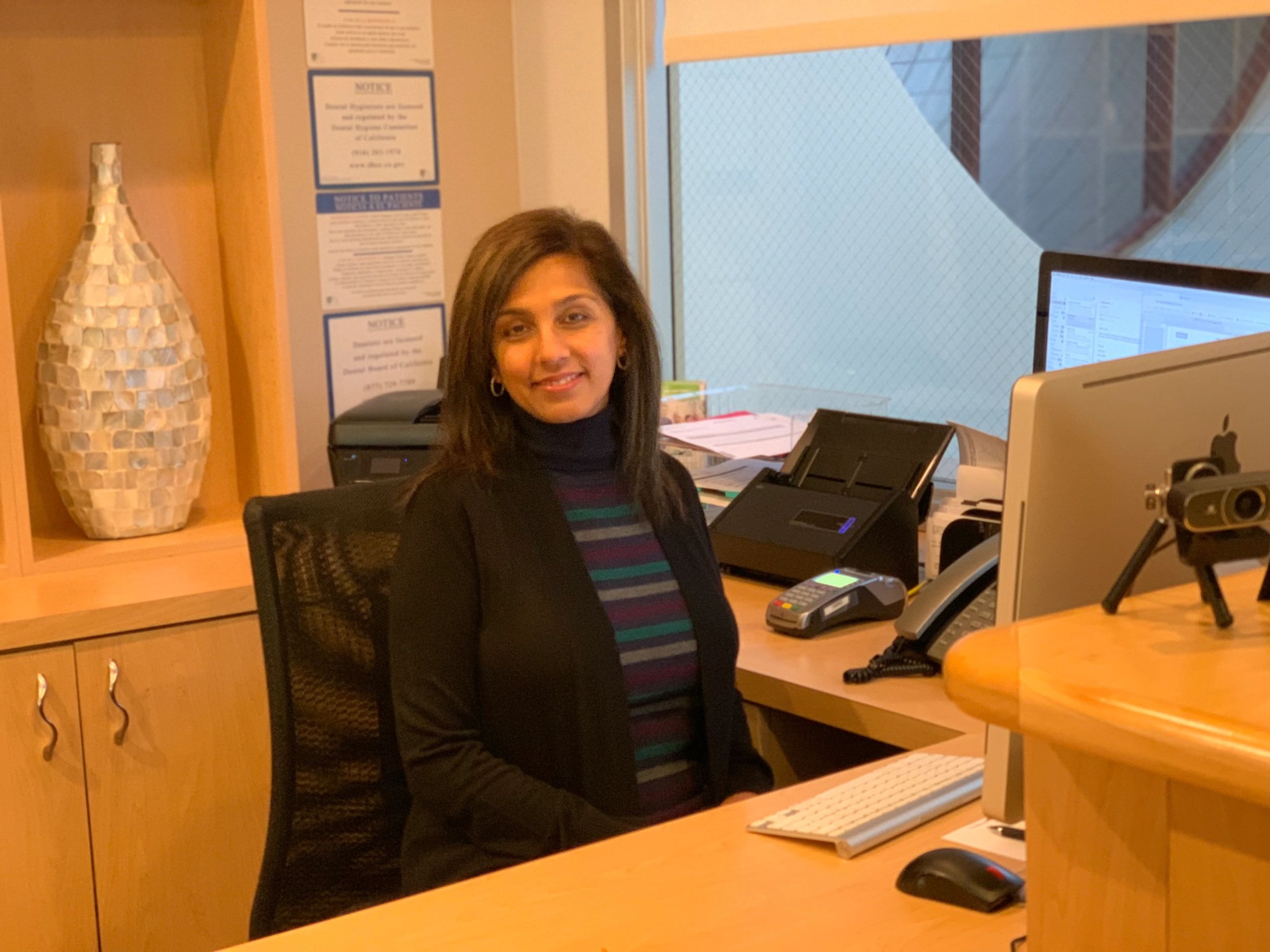 Front desk team member smiling