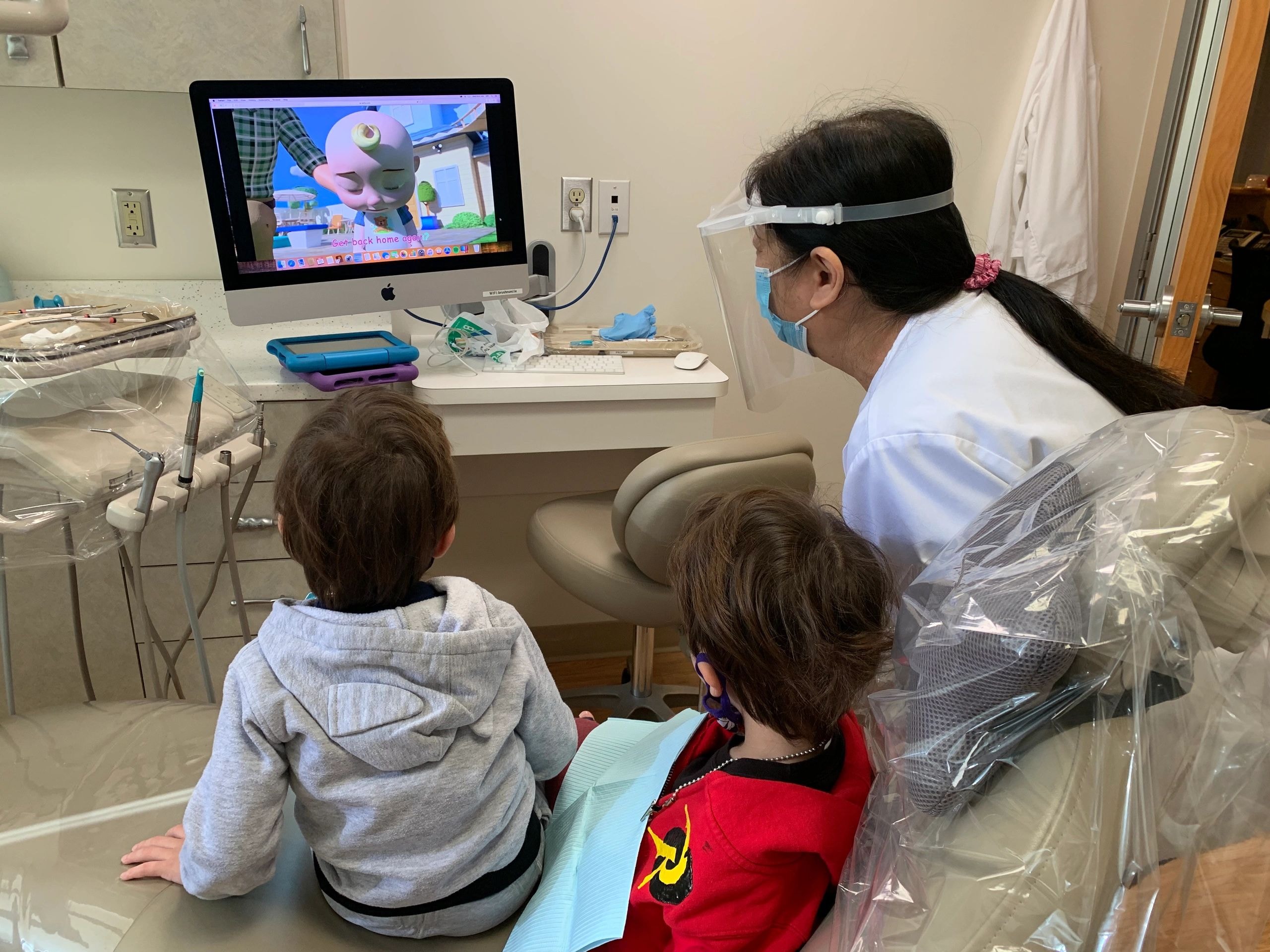 Pediatric dentist showing children animated video