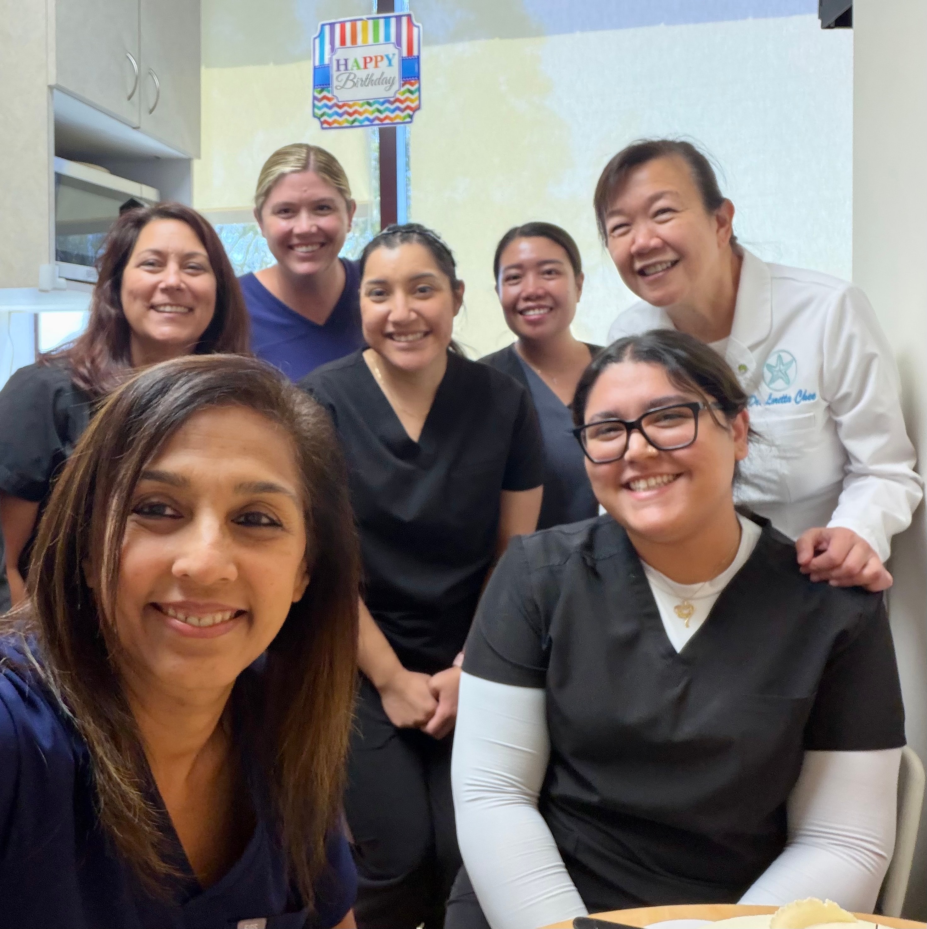 Loretta Chee DDS team celebrating together in the office